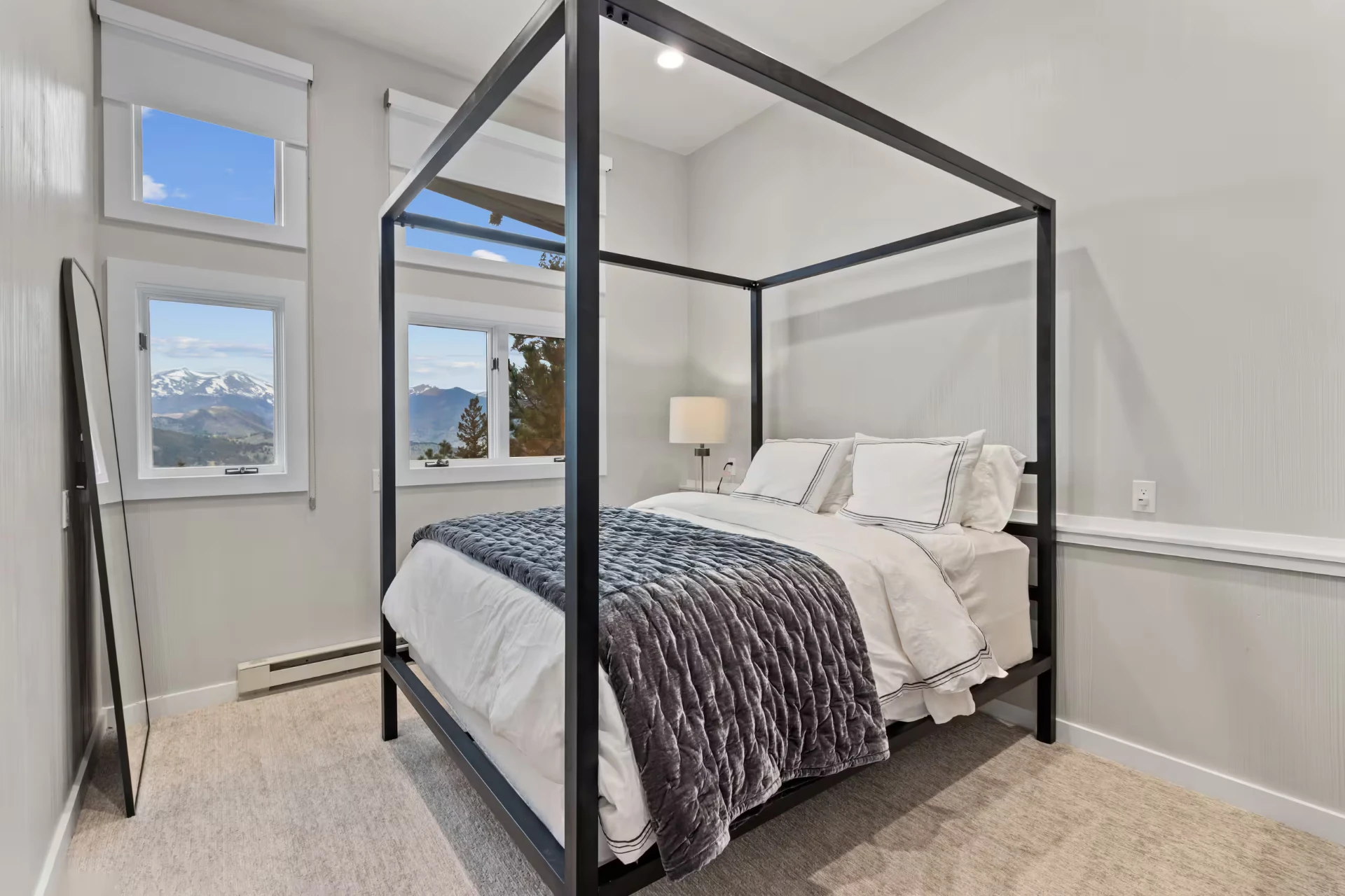 Guest bedroom with canopy bed and mountain views