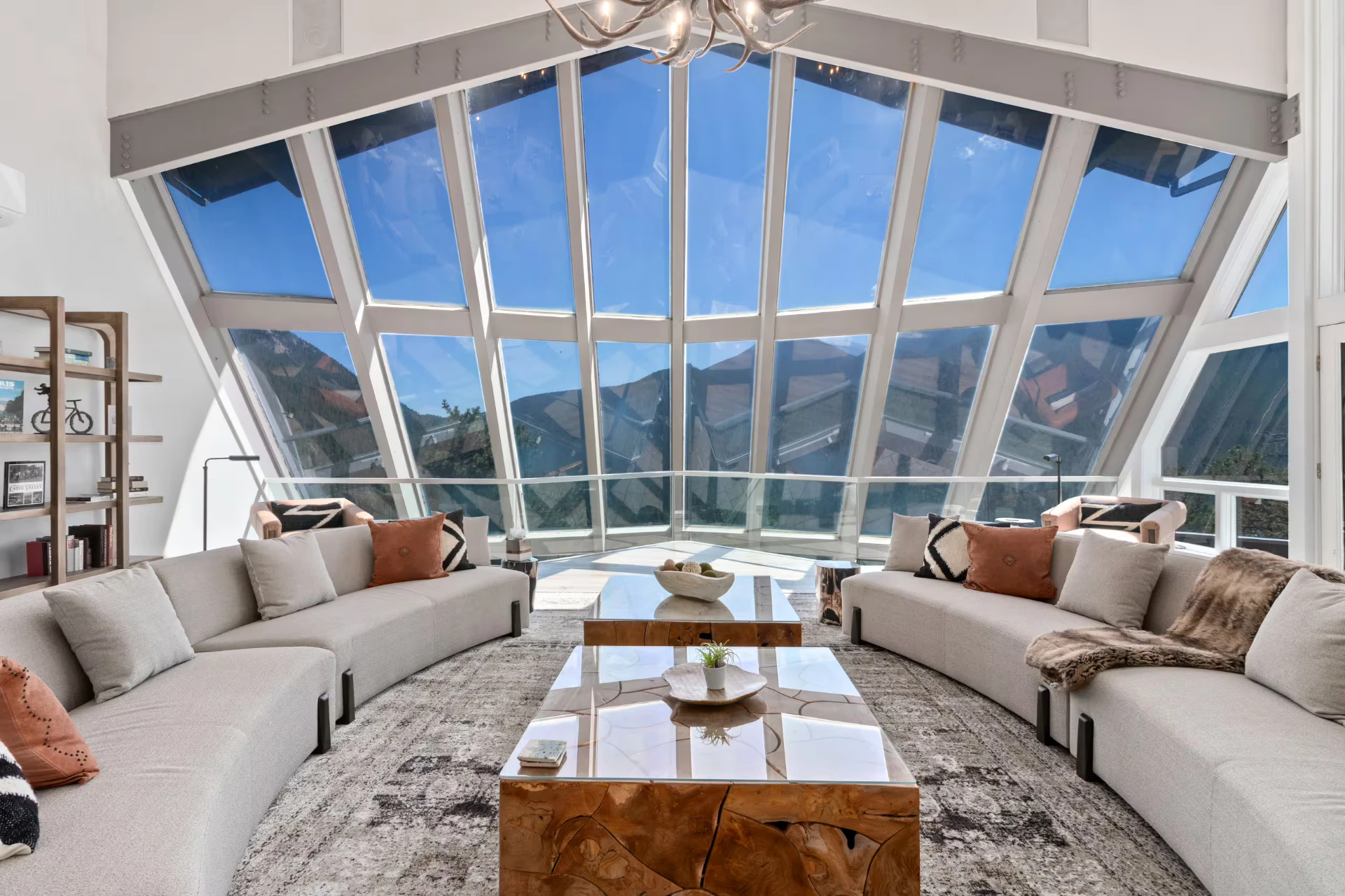 The retreat great room with floor-to-ceiling windows framing the Rocky Mountains